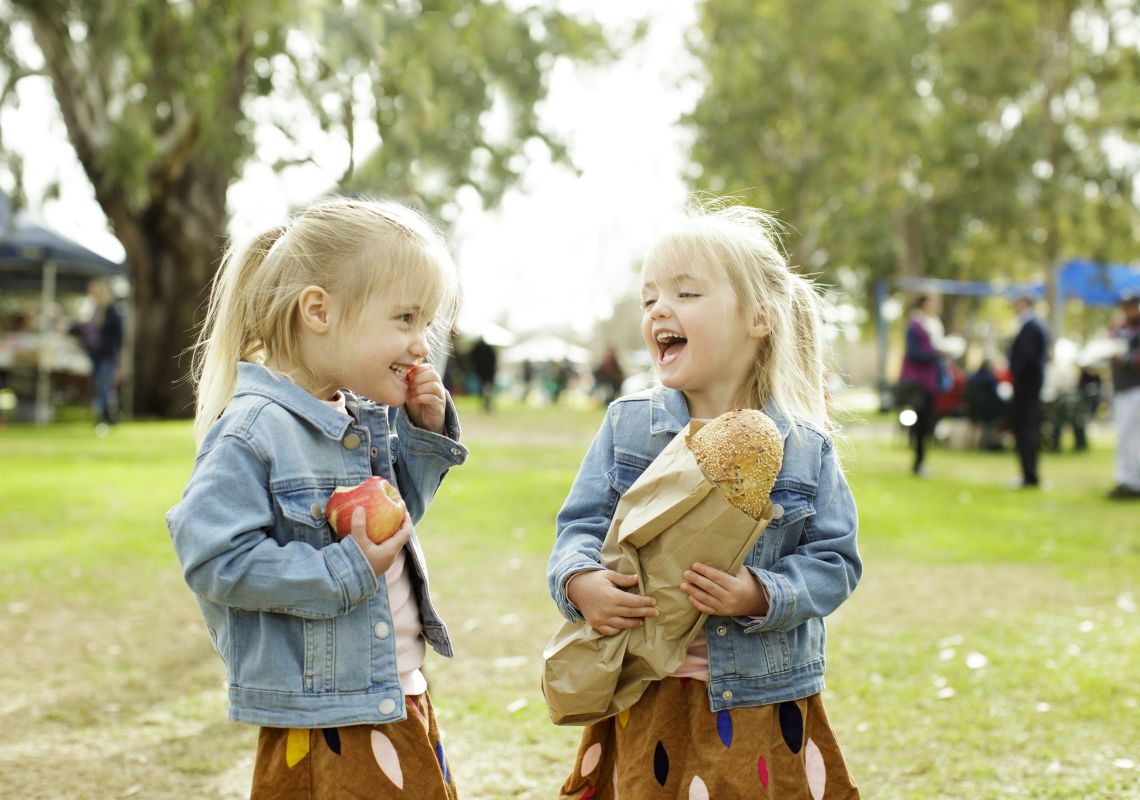 Young girls with their freshly baked loaf of Farmer's Bakehouse bread at the Dubbo Farmers Market