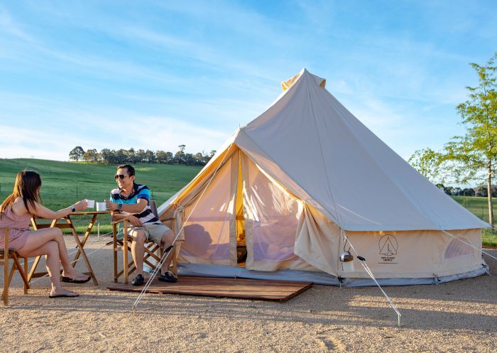 Couple enjoying a coffee outside their glamping accommodation at Mayfield Garden, Oberon