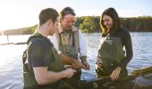 Couple enjoying a tour with Captain Sponge's Magical Oyster Tours on Pambula River, Pambula.