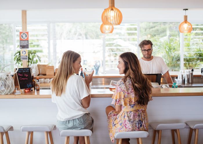 Women enjoying drinks at Avoca Beach House, Avoca Beach