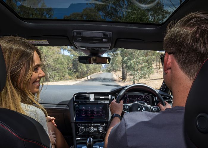 Couple driving through Wolgan Valley, Blue Mountains