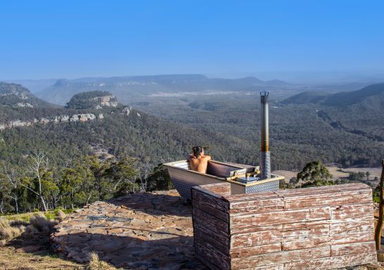 Woman enjoying Bubbletent Australia's outdoor bathtub with scenic views, Capertee Valley