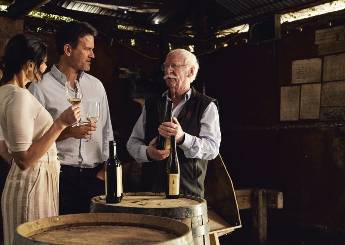 Couple enjoying a wine tasting experience with Ken Helm of Helm Wines, Murrumbateman