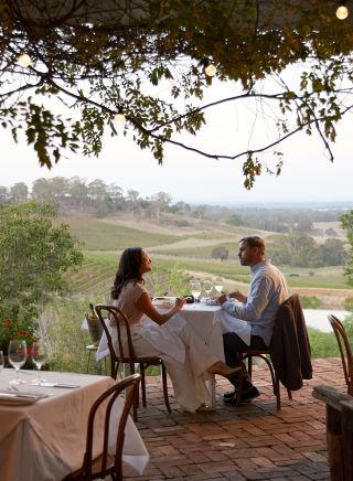 Couple enjoying food and drink at Bistro Molines, Mount View