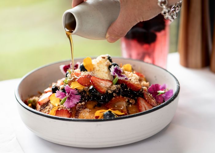 Sorensens Glasshouse & Gardens, Leura Maple syrup being drizzled over a dish at Sorensens Glasshouse & Gardens, Leura