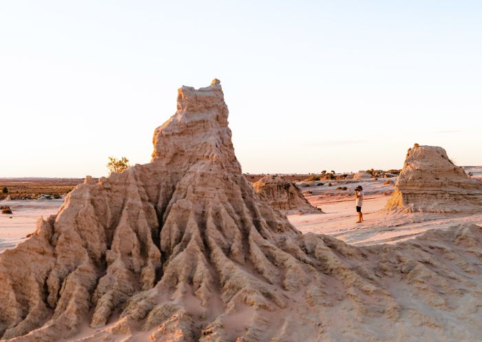 Man taking photographs of the Walls of China in Mungo National Park, Mungo