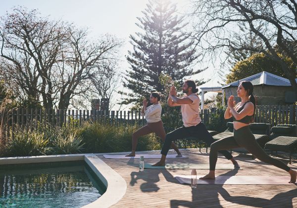 Group yoga by the pool at Greyleigh, Kiama