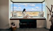 Woman enjoying coffee with a view of Wilga Station, Evans Plains