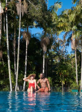Couple enjoying the pool by the sub tropical rainforest at Crystalbrook, Byron Bay