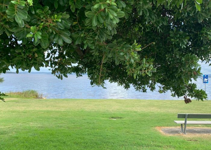 Park bench overlooking the water at Canton Beach Holiday Park, Canton Beach