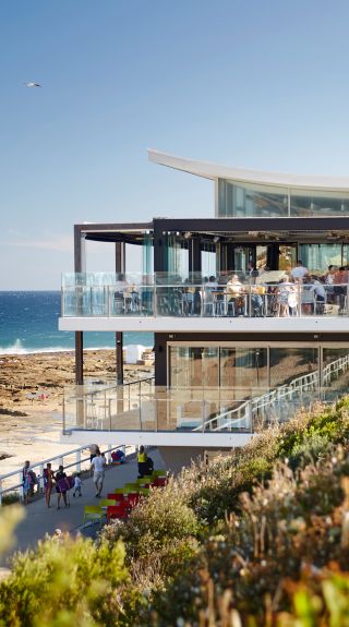 People enjoying food and drink with ocean views at Merewether Surfhouse, Newcastle